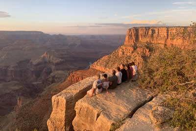 Group sitting at Grand Canyon National Park at Sunset
