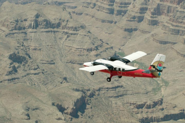 a canyon with a plane flying in the air