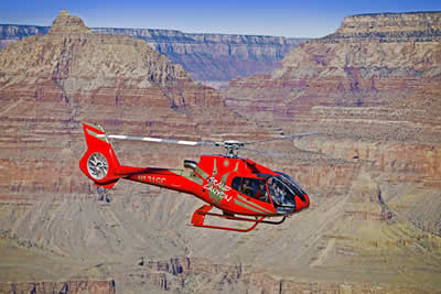 a person flying through the air on top of a mountain