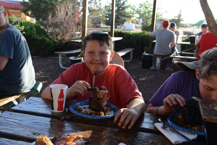 a group of people sitting at a picnic table