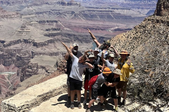 a group of people standing in a canyon