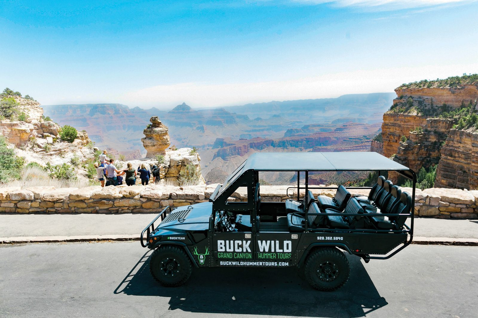 A car in front of the grand canyon