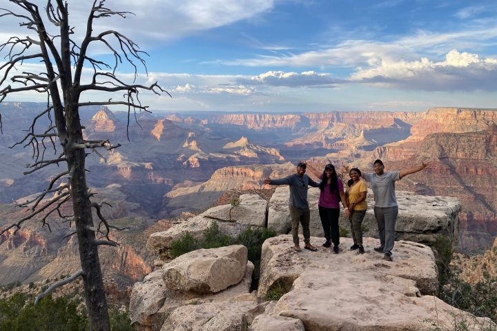 a group of people standing on top of a mountain