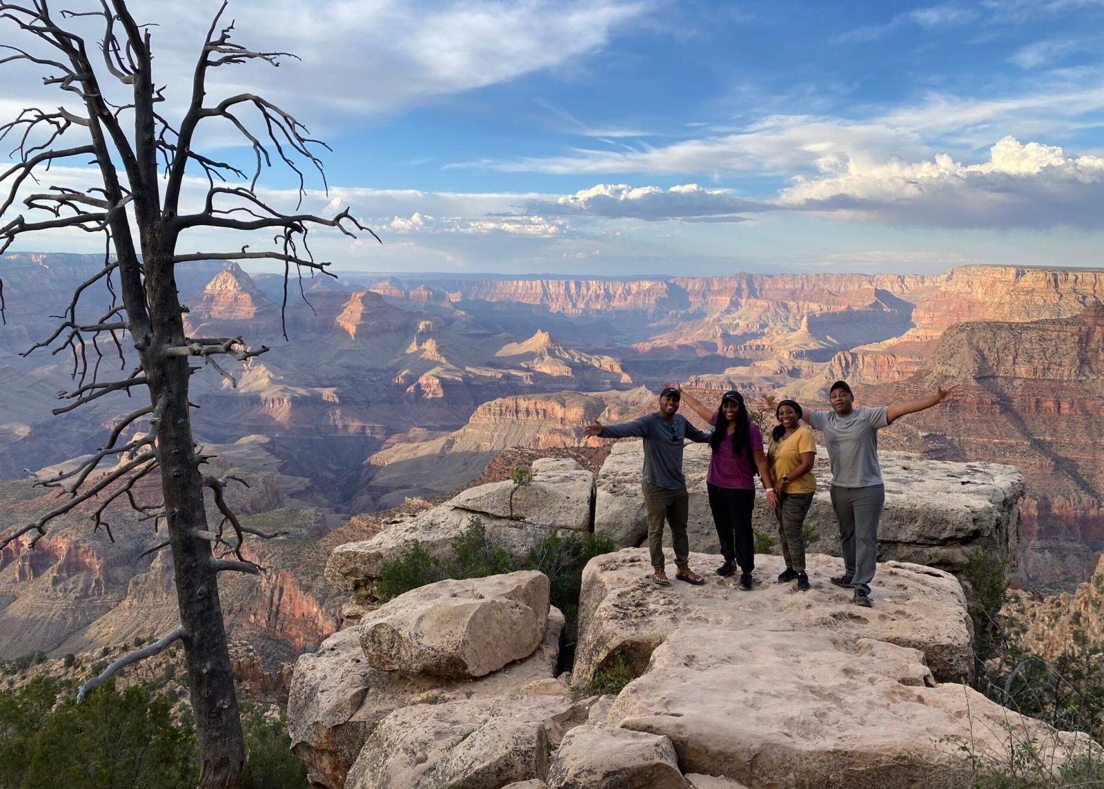 a group of people standing on top of a mountain