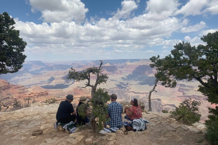 a group of people sitting on a hill