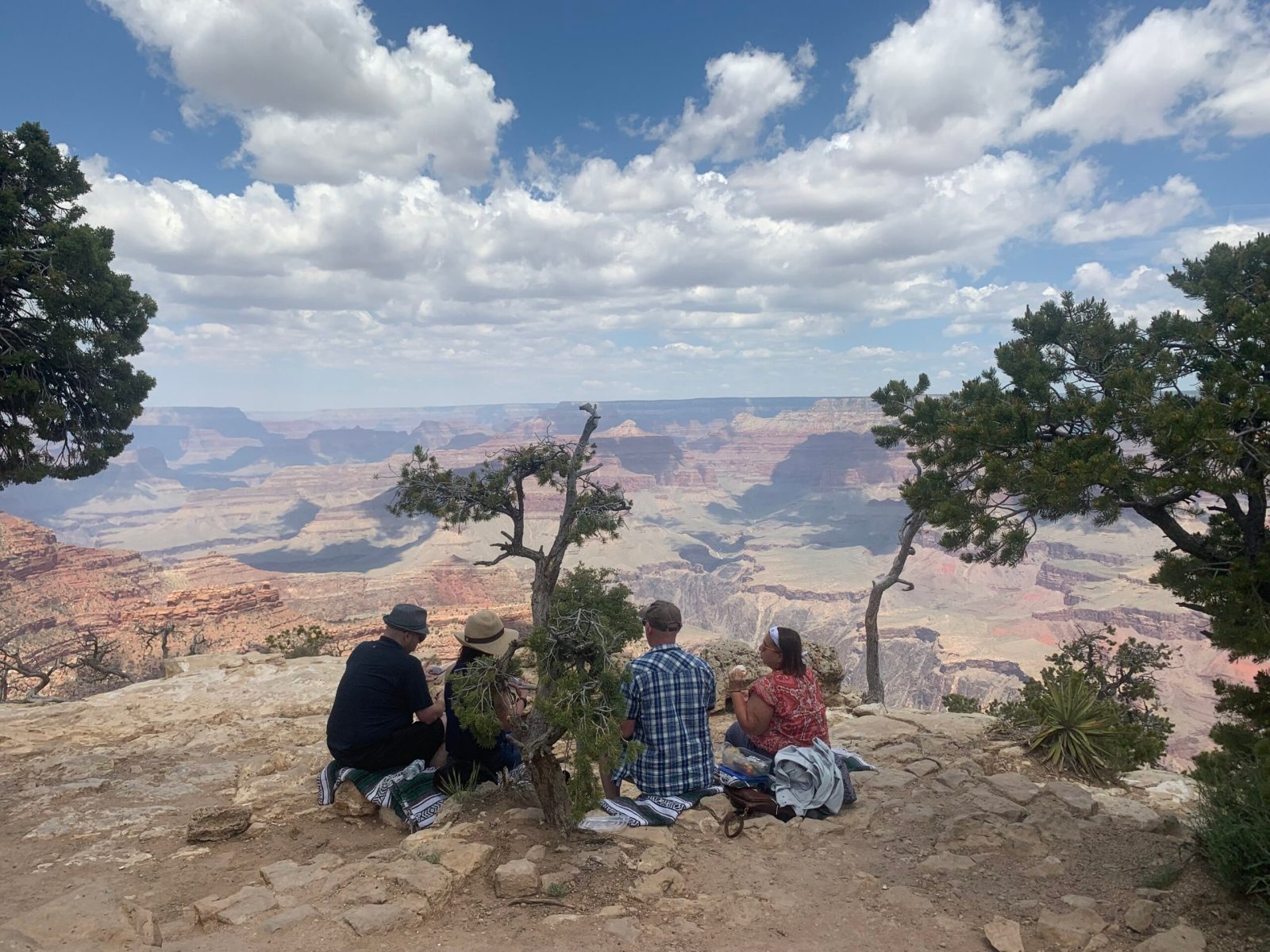 a group of people sitting on a hill