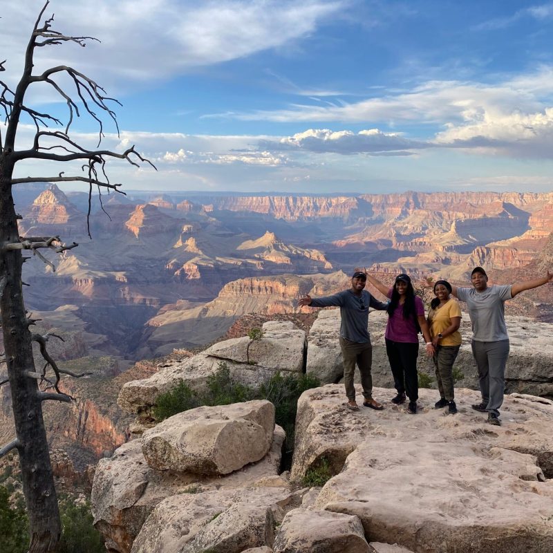 a group of people standing on top of a mountain